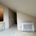 Floor-mounted mini-split heat pump indoor unit installed in a loft area by Americool Comfort in San Jose